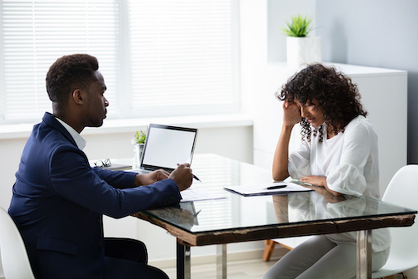 Stressed young business woman holding her head at interview