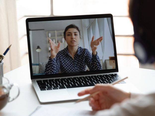 Employee on video call with a co-worker