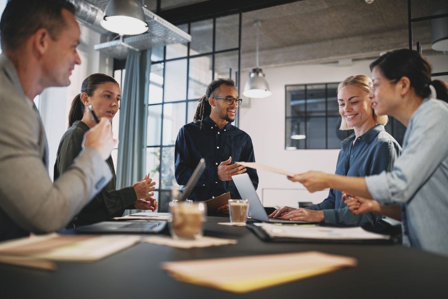 employees standing around board room table