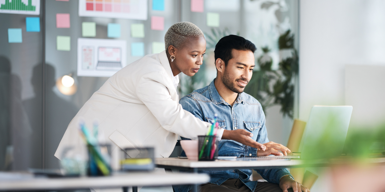 Older female employee managing and giving guidance to her direct report