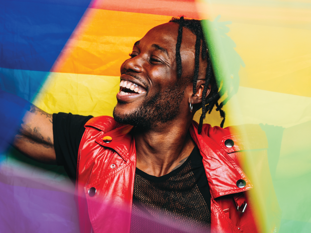 Photo of a smiling man surrounded by colors