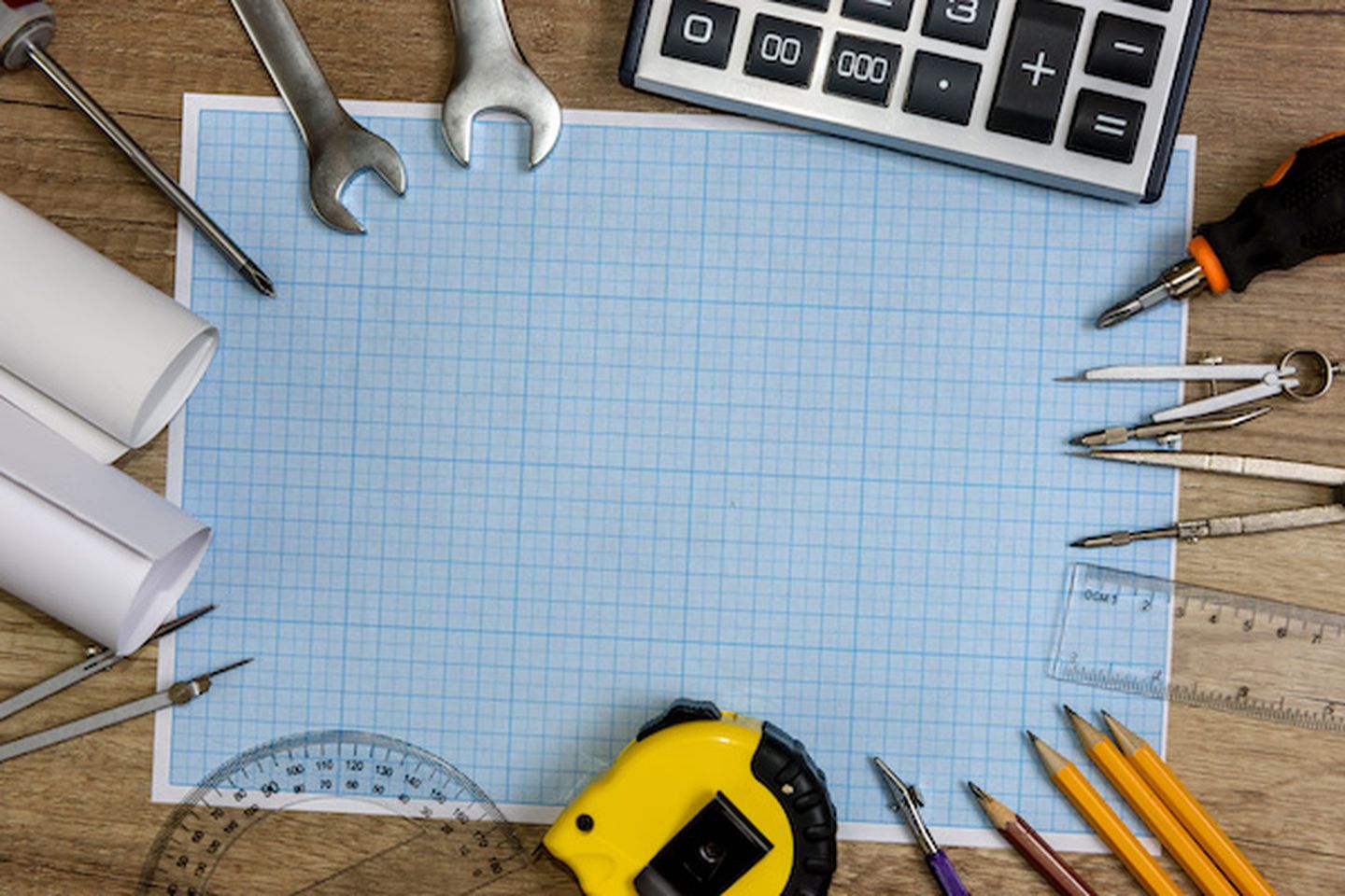 Drawing tools with millimeter paper on wooden table