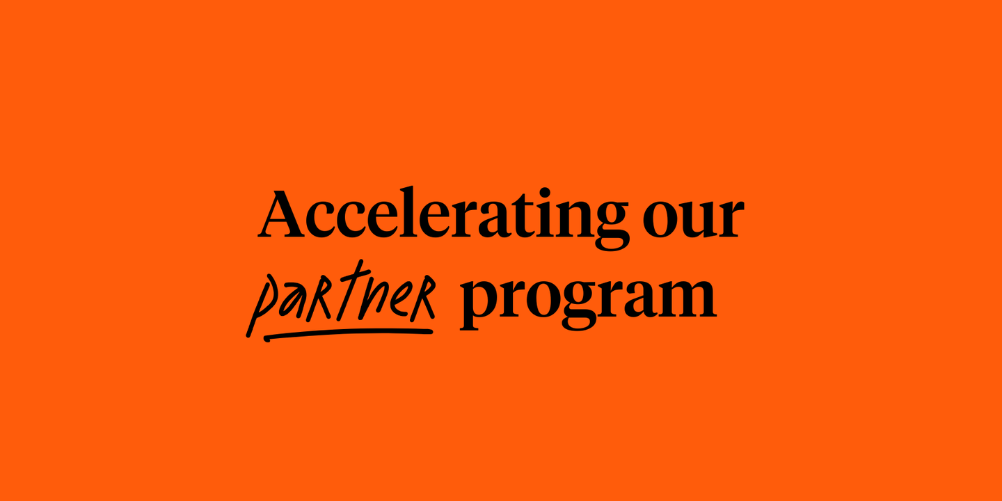 Text reading "Accelerating our partner program" on an orange background
