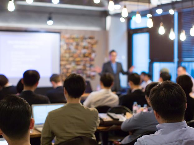 Business people meeting and working while business executive lead presenter speaks to group of successful technology entrepreneurs consultant advisor growth training lecture defocused blurred