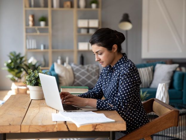 Employee sitting at desk working on laptop