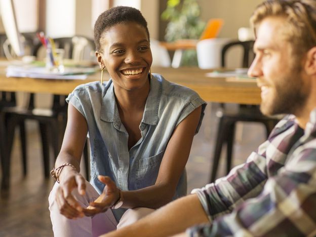 Smiling casual business people talking in office