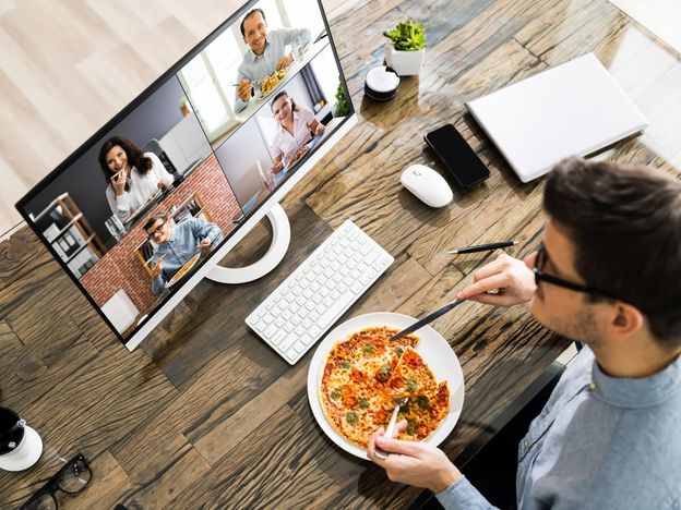 Man eating dinner while on zoom