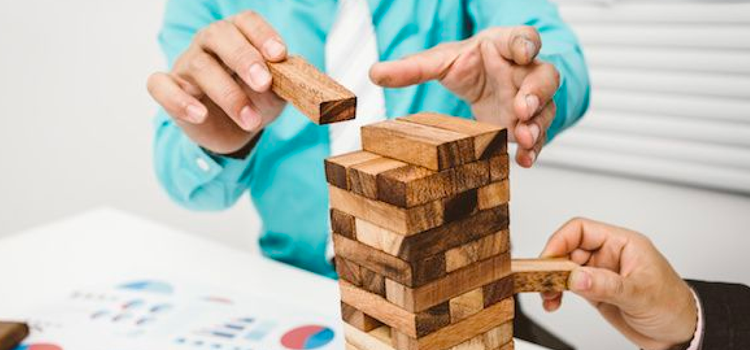 Two people playing Jenga as an icebreaker game