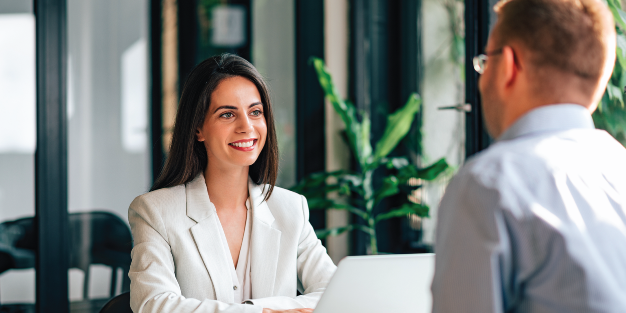 Two employees talking face-to-face during a one-on-one meeting