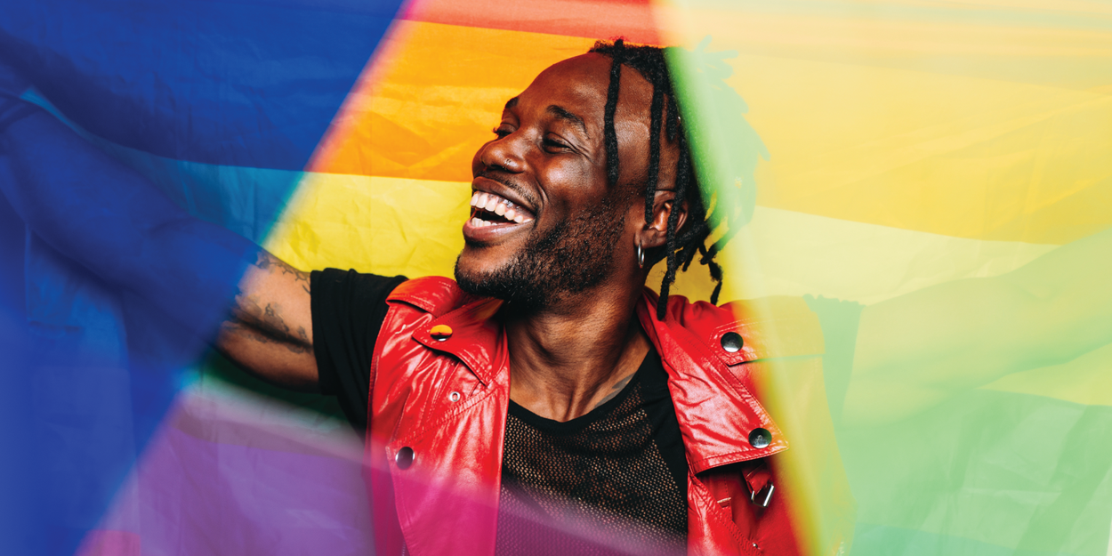 Photo of a smiling man surrounded by colors