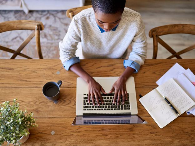Focused young african american female entrepreneur working from her home