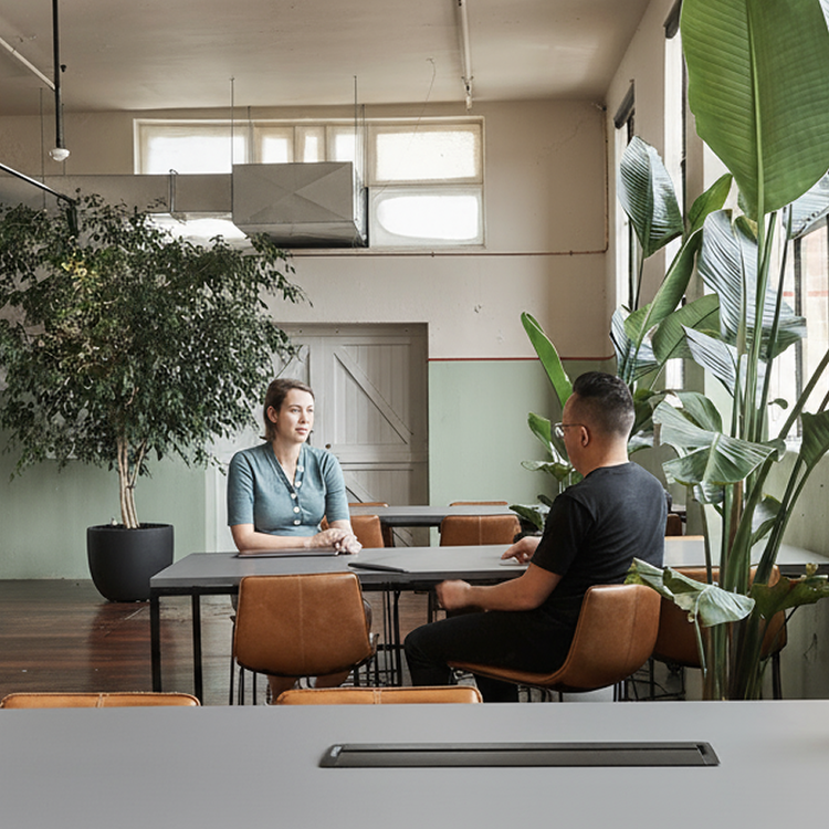 Two employees having a conversation at an office table