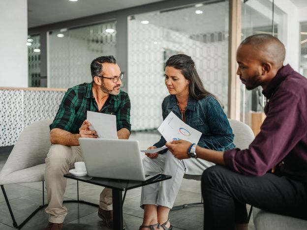 Casual meeting of diverse business team analyzing financial data