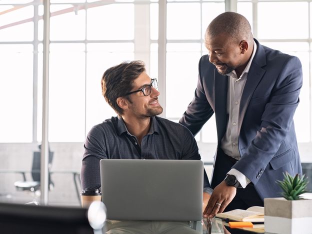 Mature executive helping new employee