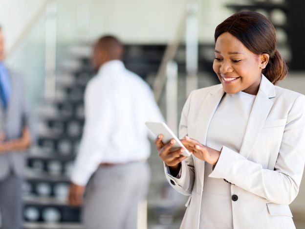 Young african american career woman using cell phone