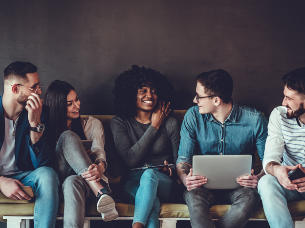 Five people sitting on a couch together