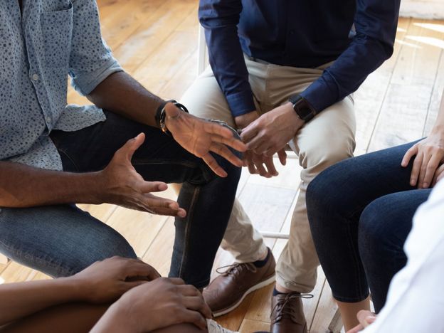 African man counselor speak at group counseling therapy session