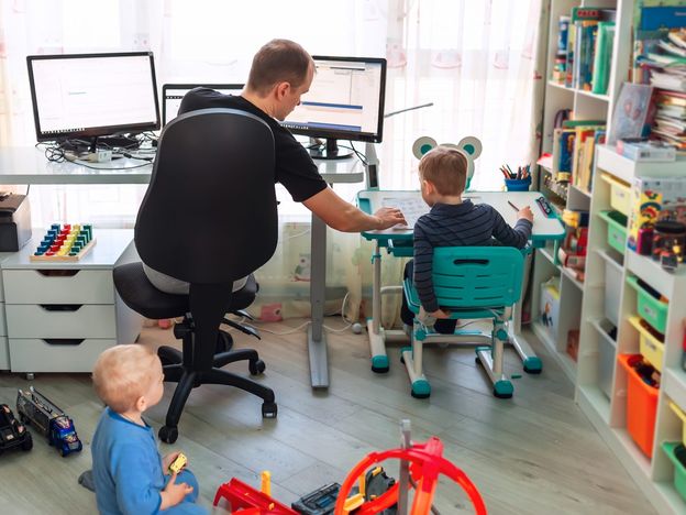 Father with kids working from home during quarantine stay at home work from home concept during coronavirus pandemic