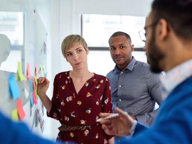 Diverse team of creative millennial coworkers in a startup brainstorming strategies