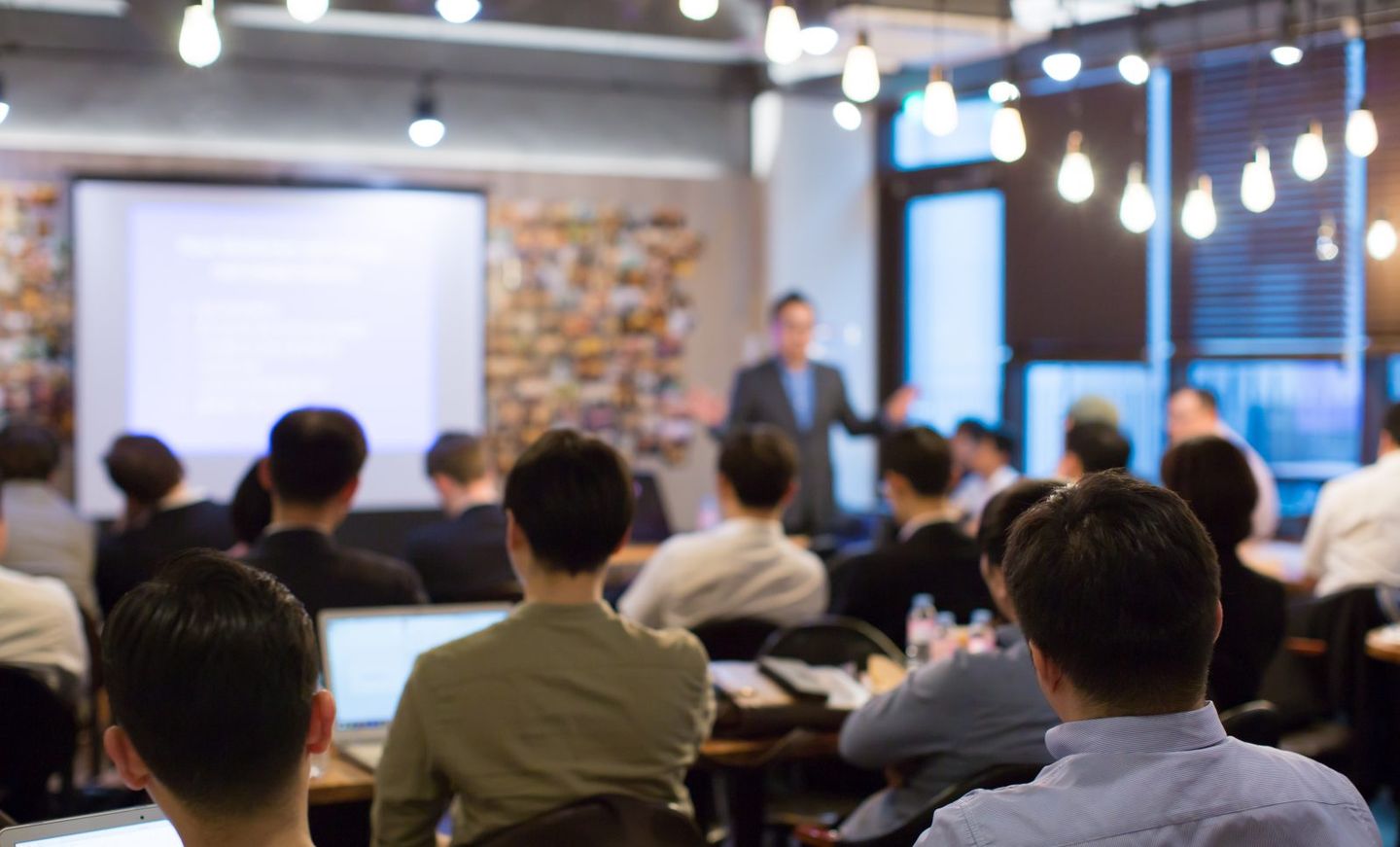 Business people meeting and working while business executive lead presenter speaks to group of successful technology entrepreneurs consultant advisor growth training lecture defocused blurred