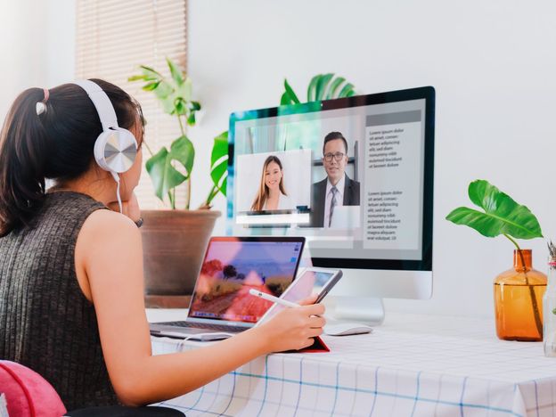 Asian business woman work from home with laptop tablet and computer on table with meeting online and video conferencing concept of social distancing to stop the spread disease of corona virus