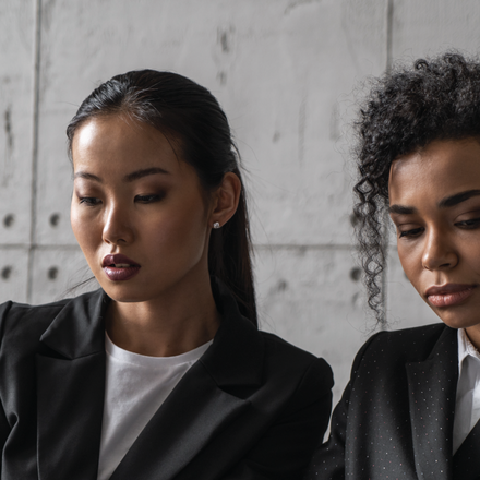 Image of two feminine-presenting individuals talking to each other