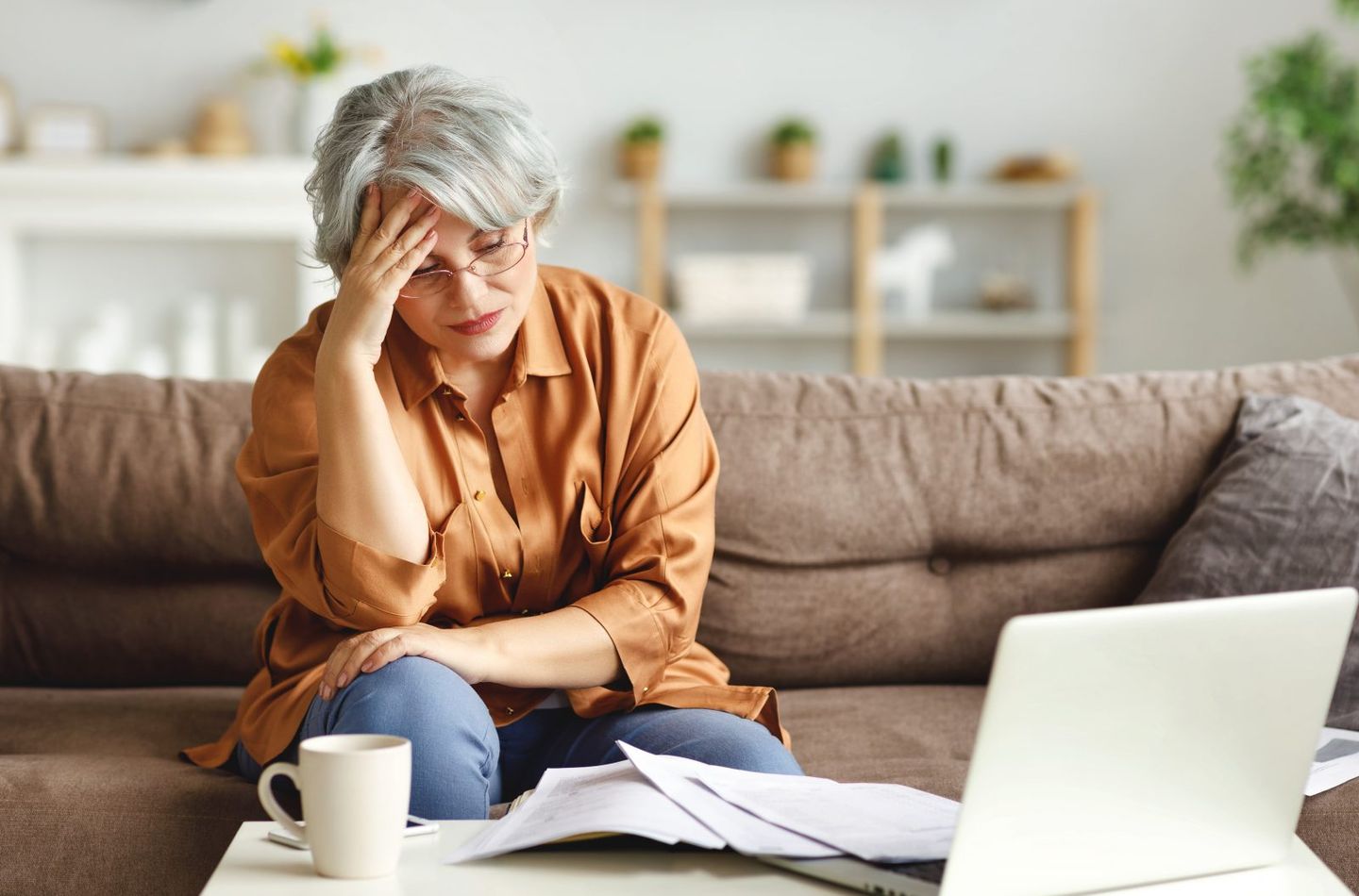 Stressed senior freelancer reading document 2