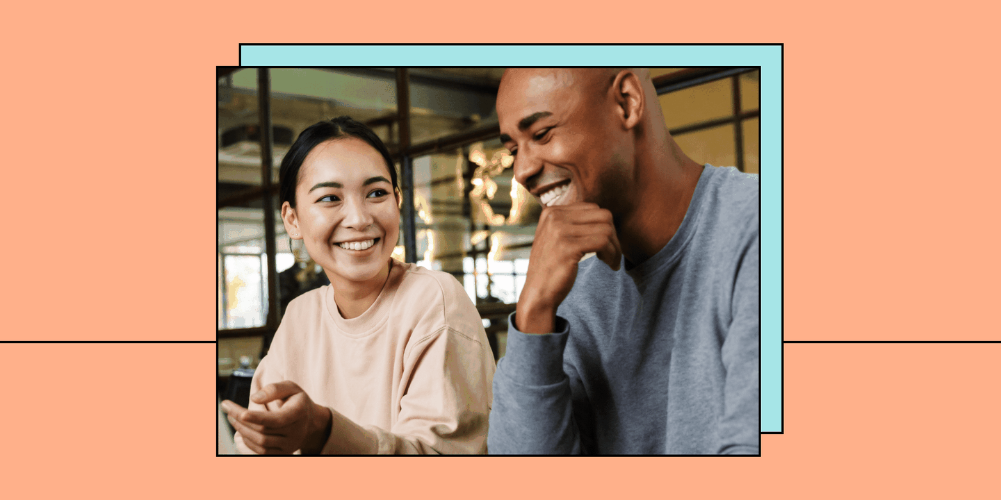 Photo of two people talking on an orange background