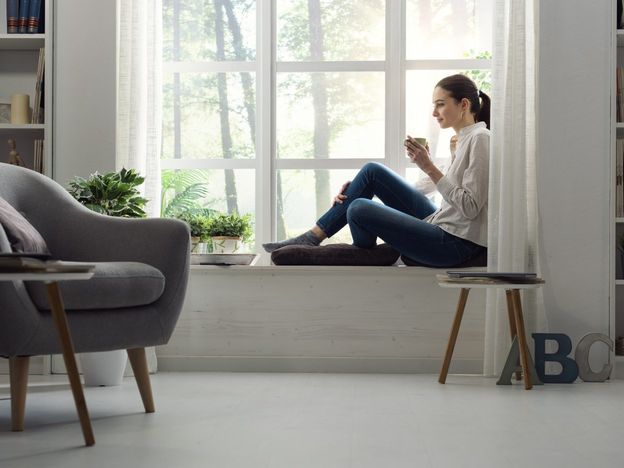 Woman relaxing at home and having coffee