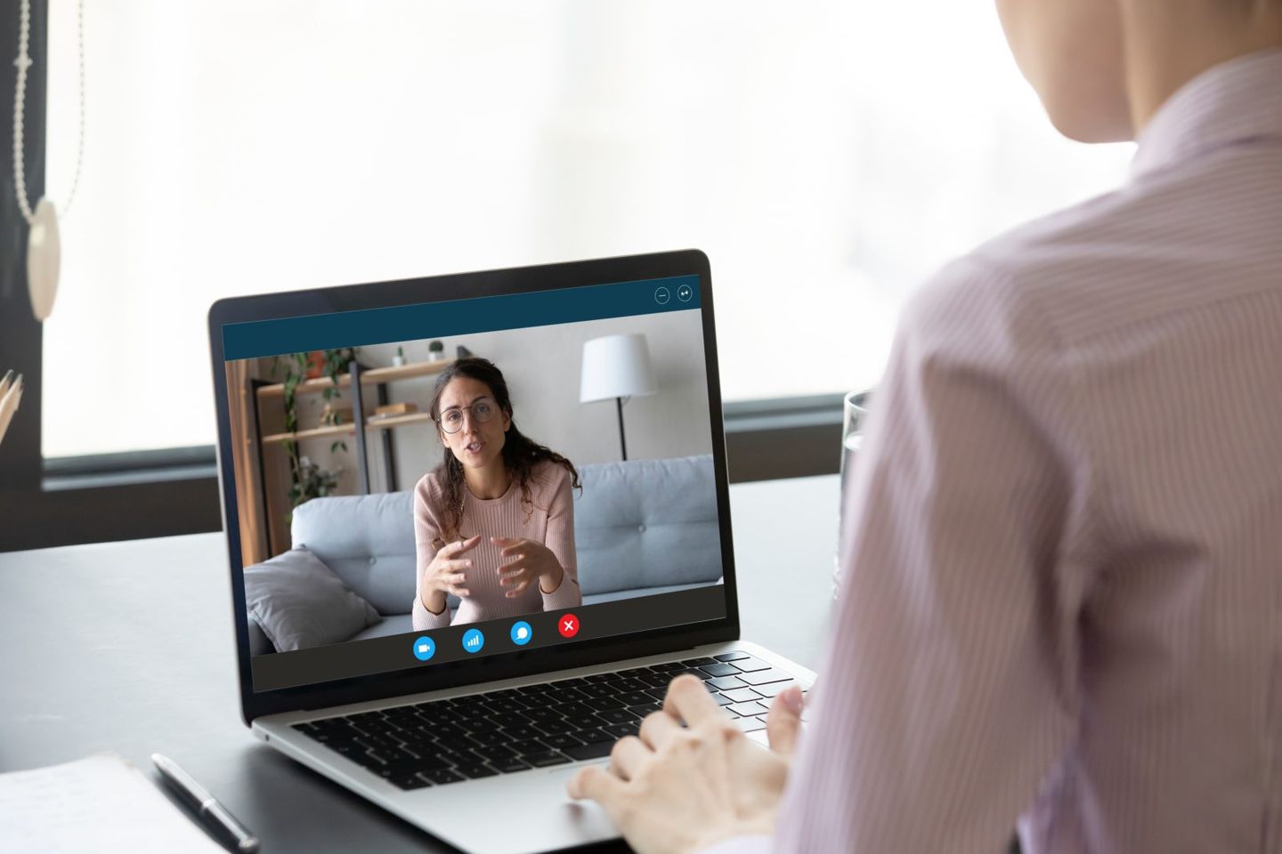 Businesswoman having distant negotiations using video conference application on pc