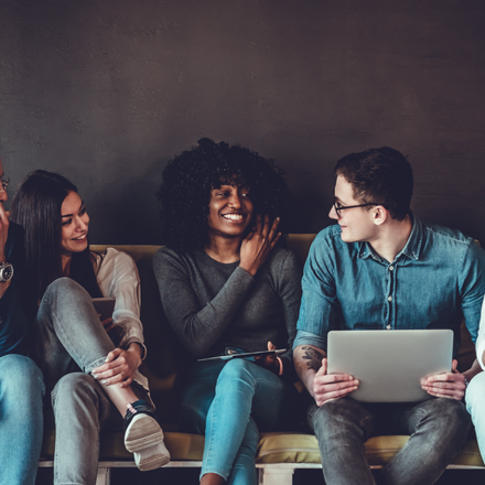 Five people sitting on a couch together