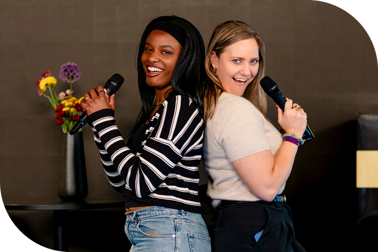 Culture Amp employees posing with microphones