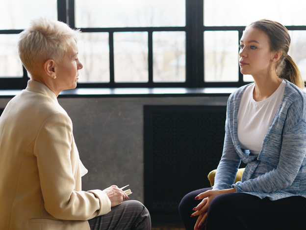 Two women sitting across from each other