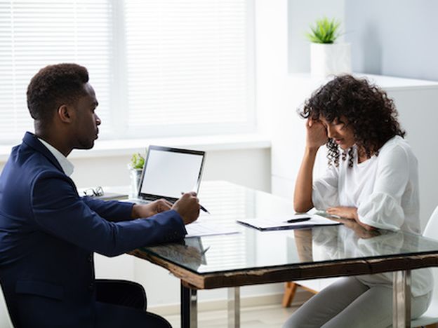 Stressed young business woman holding her head at interview