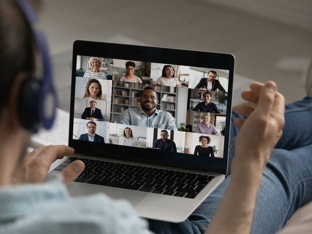 Male employee have group video call with colleagues