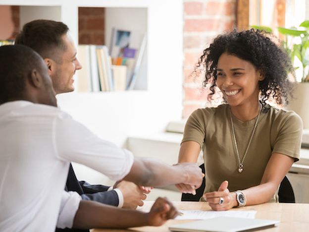 Happy female african vacancy candidate shaking hand of hr manager