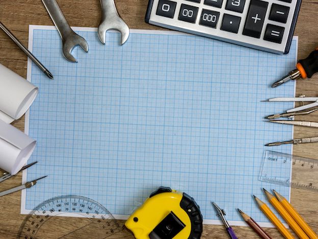 Drawing tools with millimeter paper on wooden table