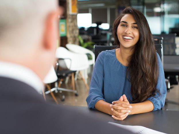 Young female candidate laughing at job interview