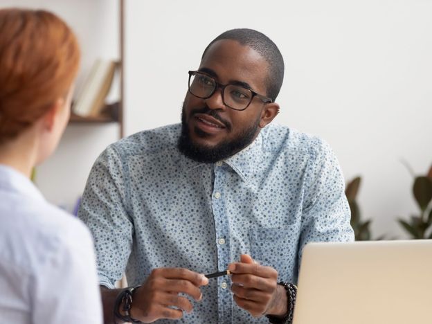 African hr manager listening to caucasian applicant at job interview