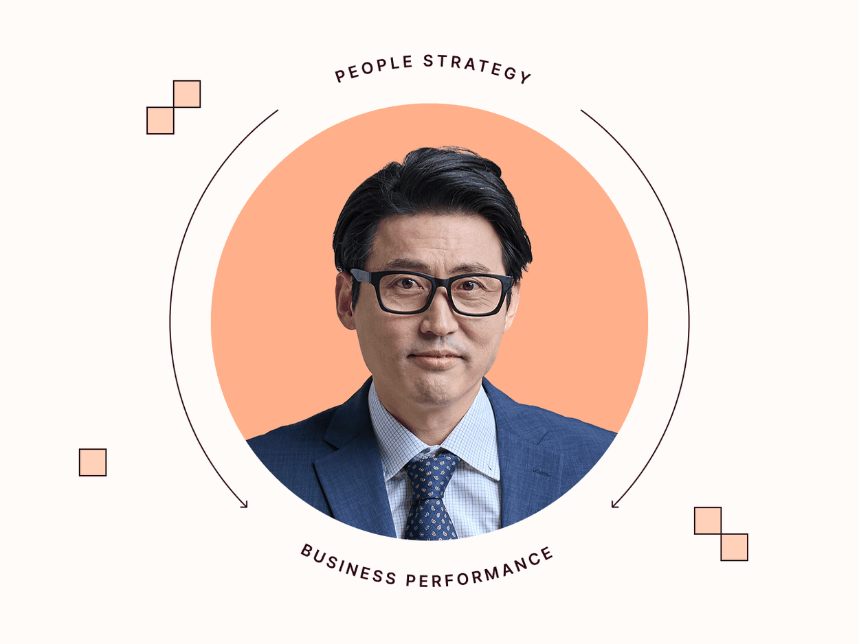 man with suit and eyeglasses in front of orange background