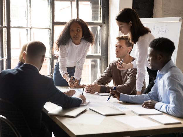 Serious diverse business team and african leader discuss financial paperwork