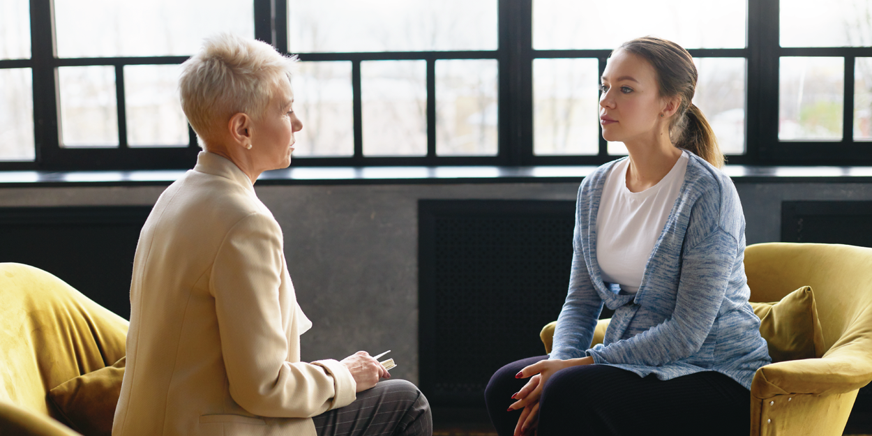 Two women sitting across from each other