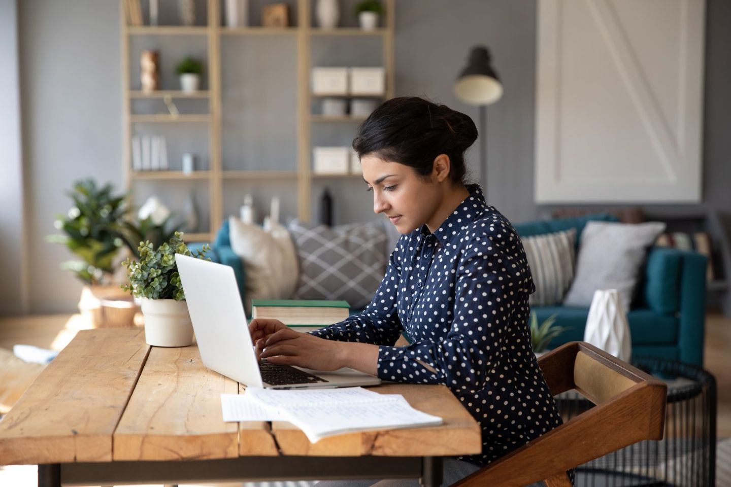 Employee sitting at desk working on laptop