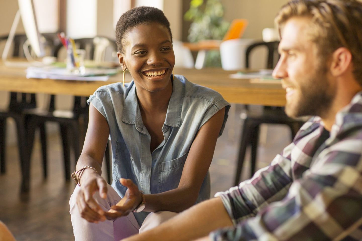 Smiling casual business people talking in office