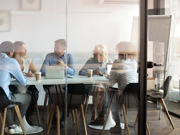 Business people negotiating at boardroom behind closed doors