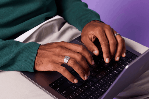 fingers typing on a laptop keyboard
