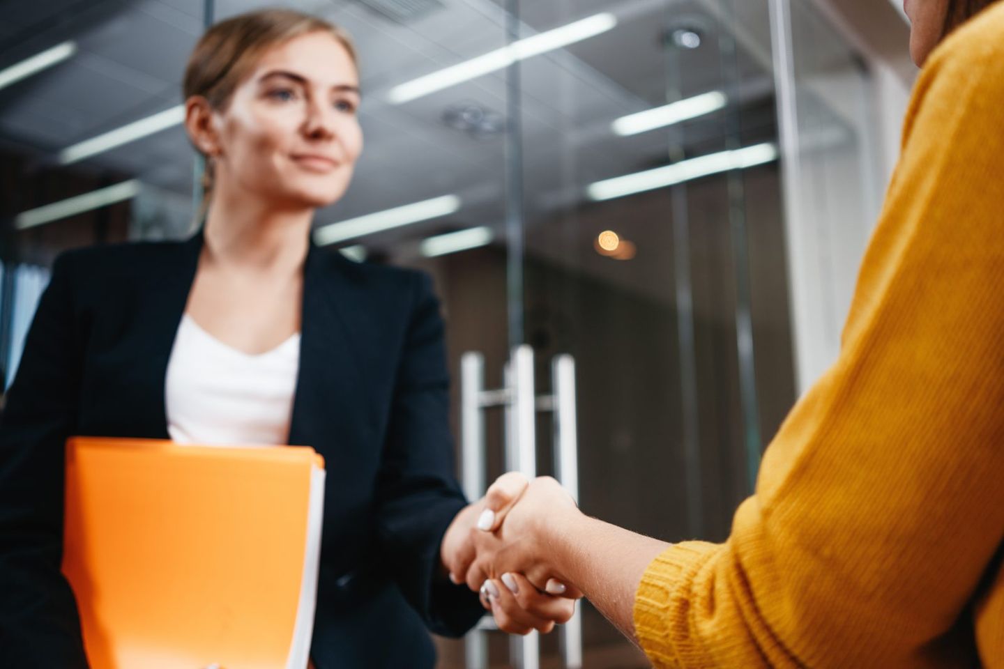 Handsome businesswomen handshaking after succsessful deal positive working moment business people partnership handshake meeting concept focus on hands