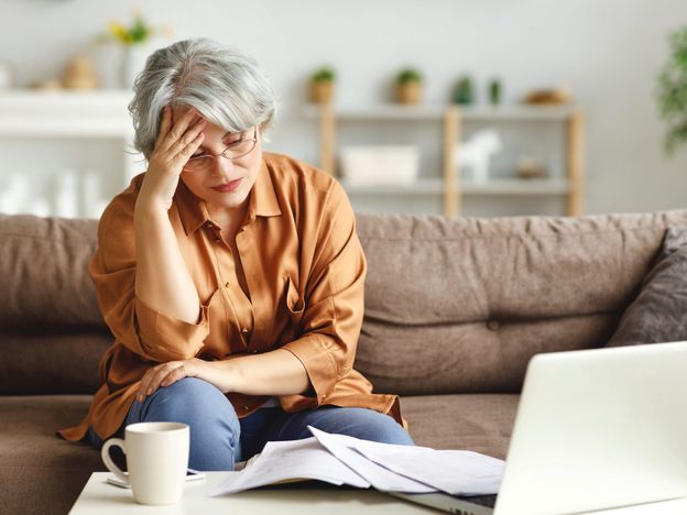 Stressed senior freelancer reading document 2