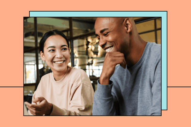 Photo of two people talking on an orange background