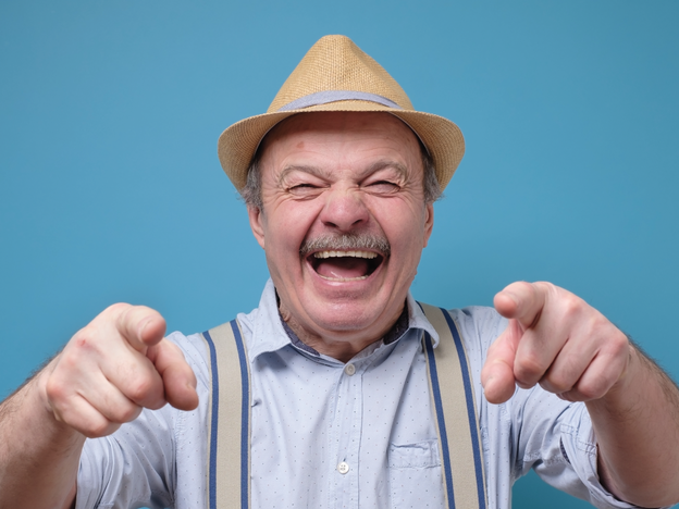 Older man pointing and laughing